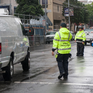 Traffic Officer directing vehicles. Links to Enforcing Traffic Laws page.