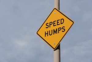 An advisory sign that reads: "SPEED HUMPS".