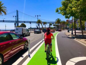 Biker on a quick-build bike lane on the Embarcadero